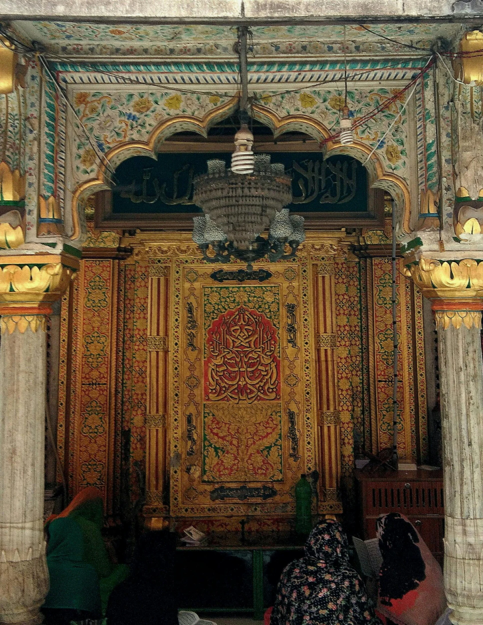 people sitting in a room under colorful decorations