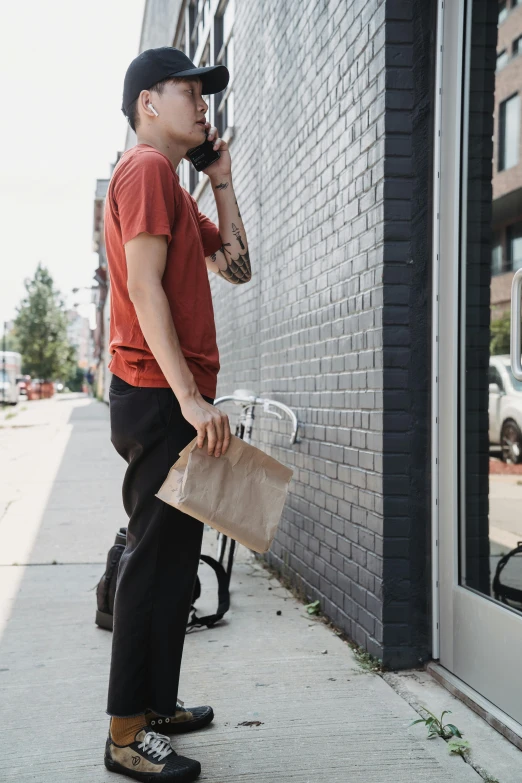 a man standing outside talking on his phone