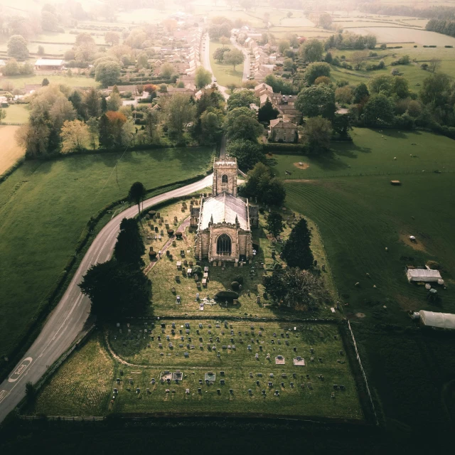 a bird's eye view of a church near a town