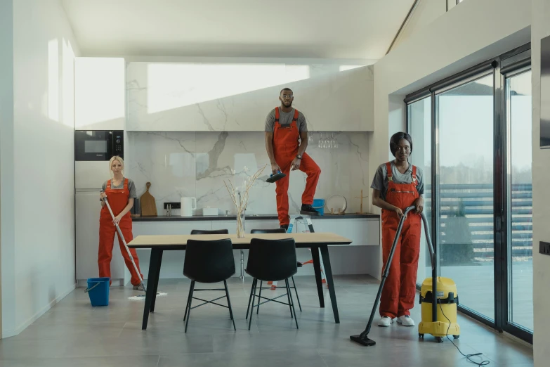 men and woman with mop and buckets on a concrete floor