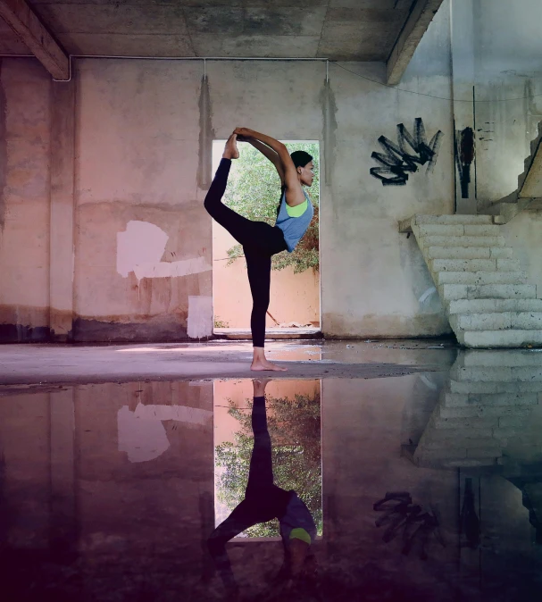 woman practicing acrobatic in a mirror still in its place