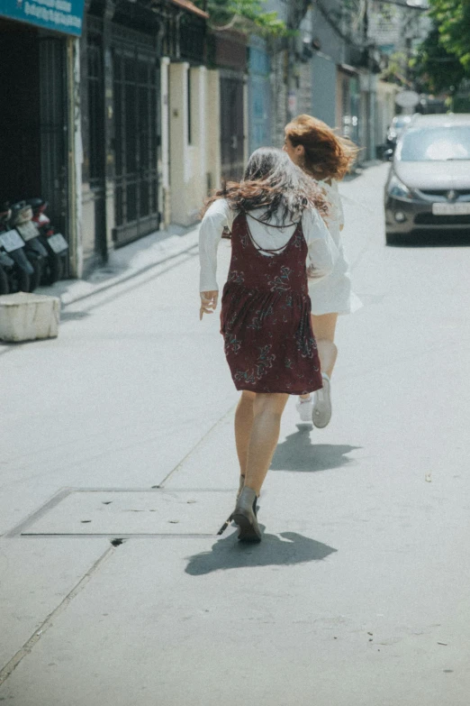 a woman with an umbrella walking on the street