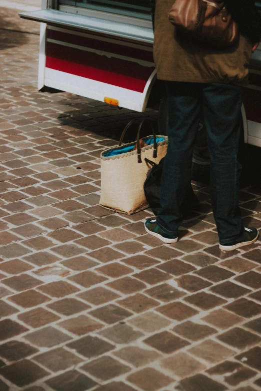 a person standing in front of a white truck with luggage