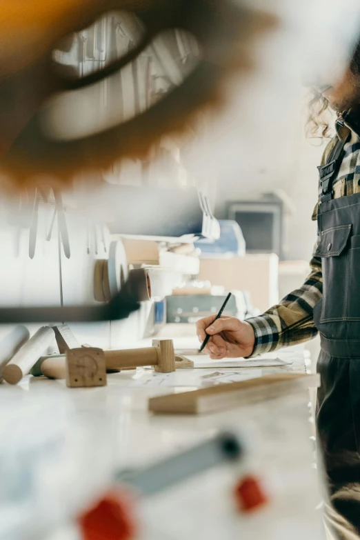 a man holding a pencil looking at a picture