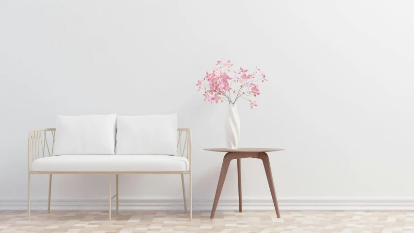 a flower vase with pink flowers is sitting on the corner table