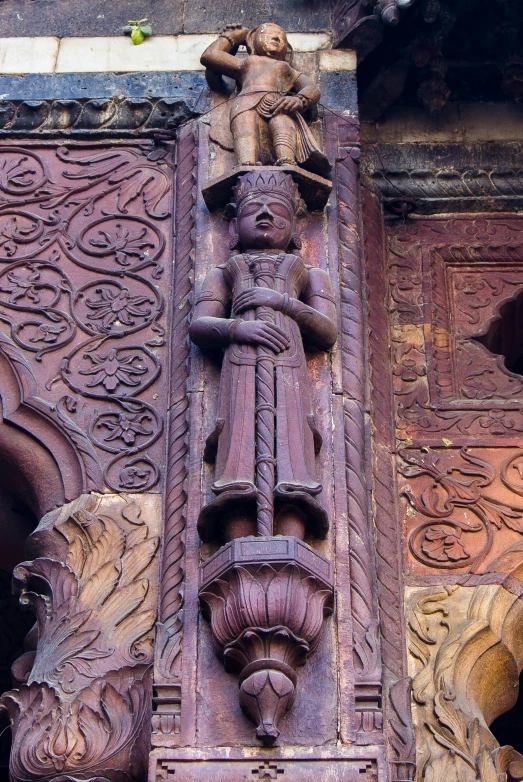 carvings are on the wall of a building