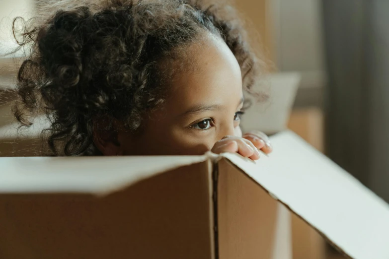 a  peeks out from inside a box