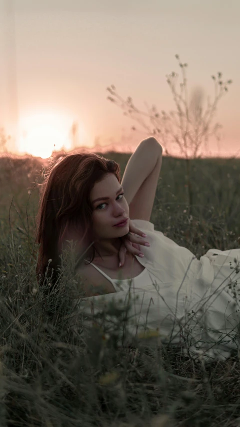 a woman posing for a po in a field