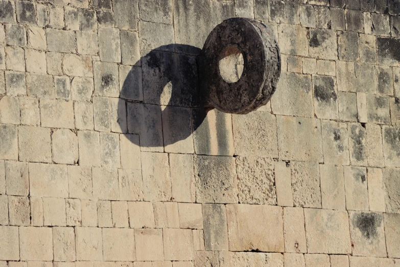 two large circular objects are hanging on a building