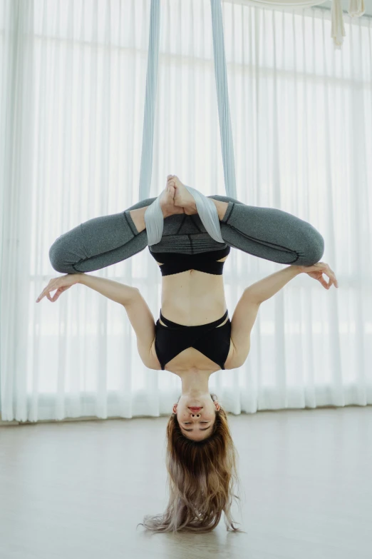 an upside down dancer in a white room