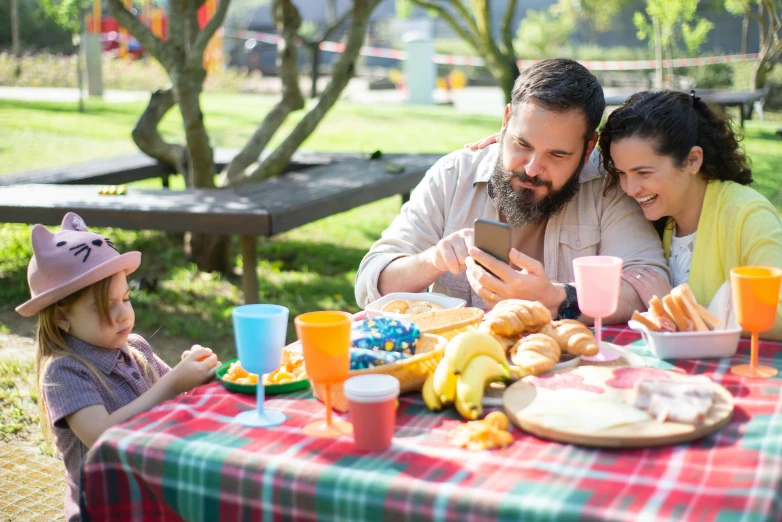 the family is enjoying a picnic at the park