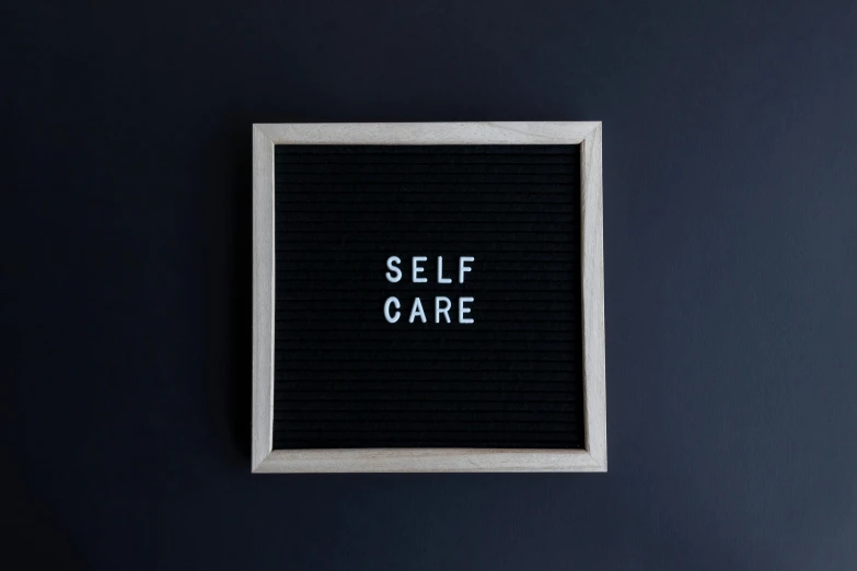 a po of a black background and white border with the word self care