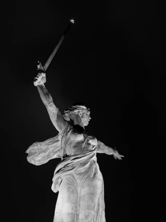 a woman statue with a bat in her hand