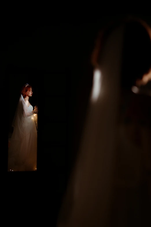 a woman in a white dress holding a wedding light