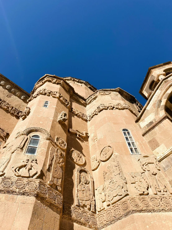 the facade of a building with a clock and two story window