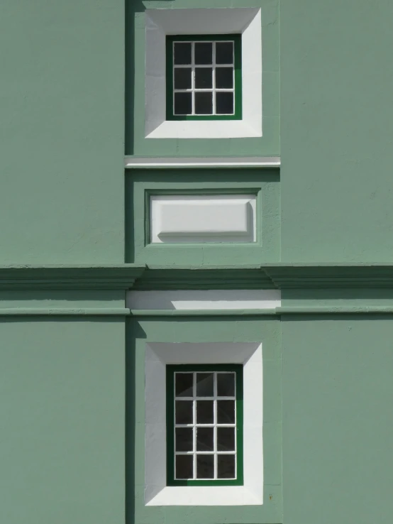 three windows that are in the side of a building