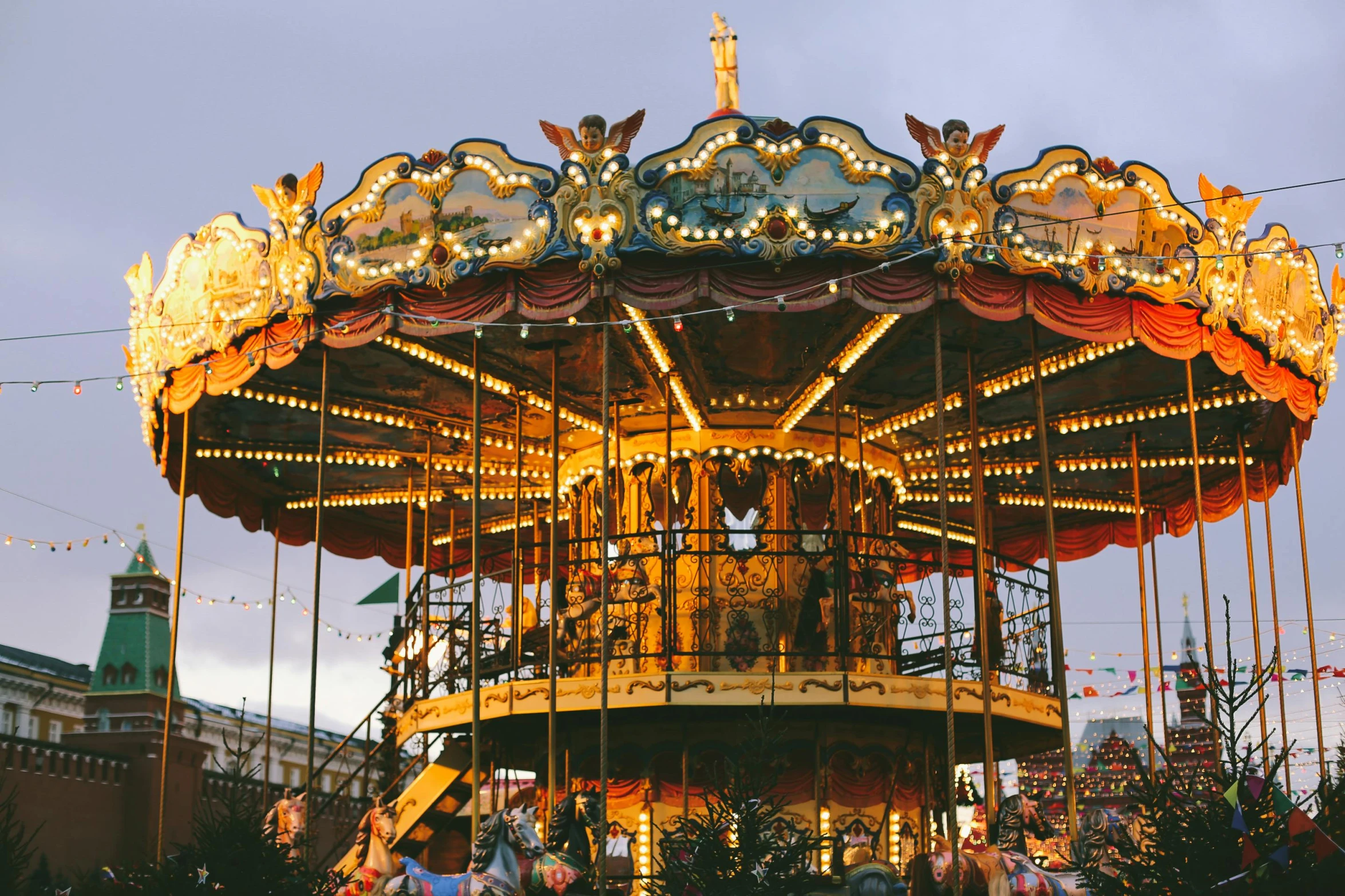 a merry go round in front of buildings at night