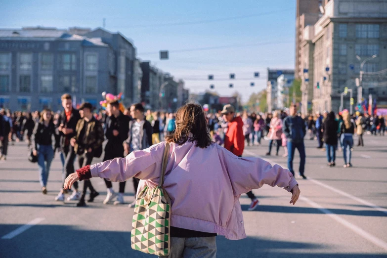 there are people walking and walking down the street