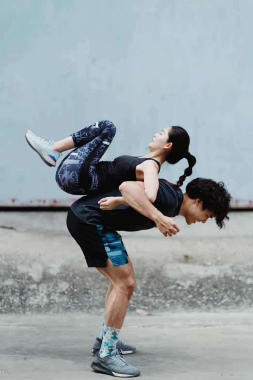 a man and woman dancing together outside in front of a building