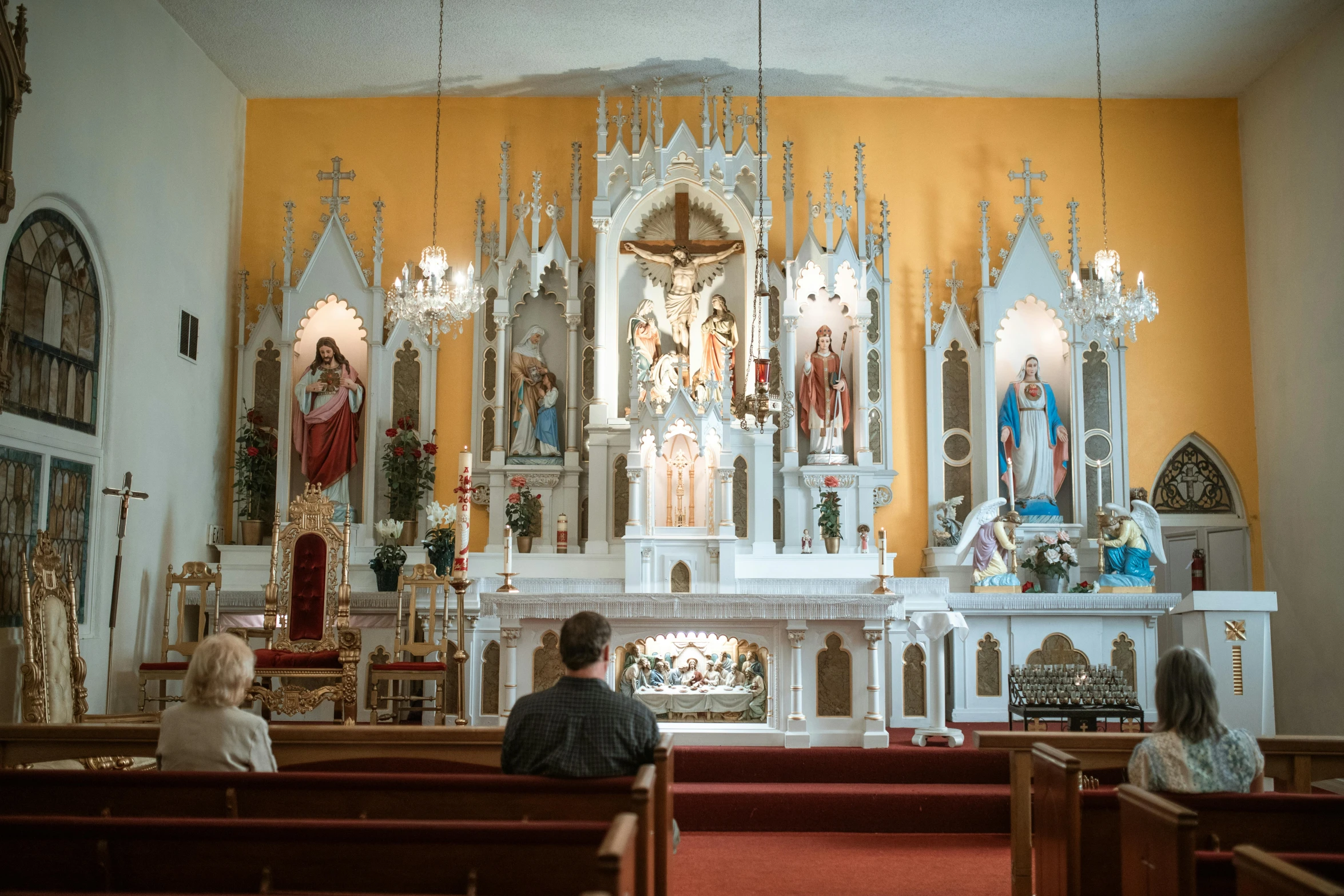 people sit at the alter as others stand before them