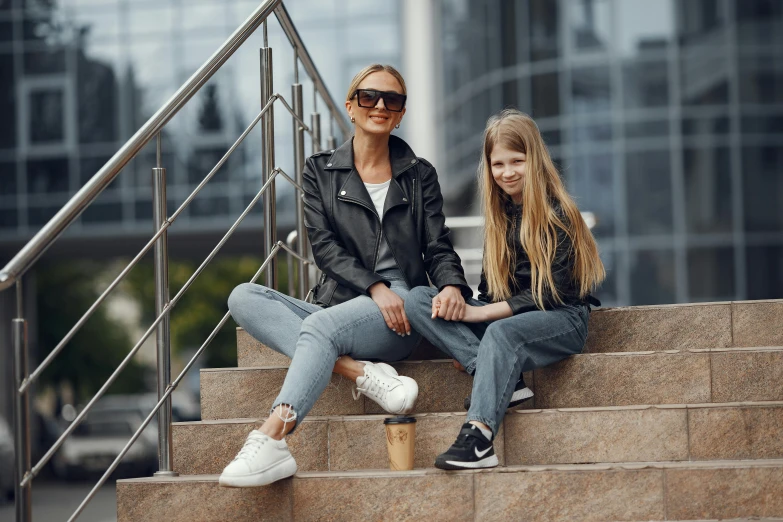 an older woman sitting on a step with a younger girl