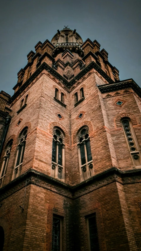 a large brick building with a steeple on top