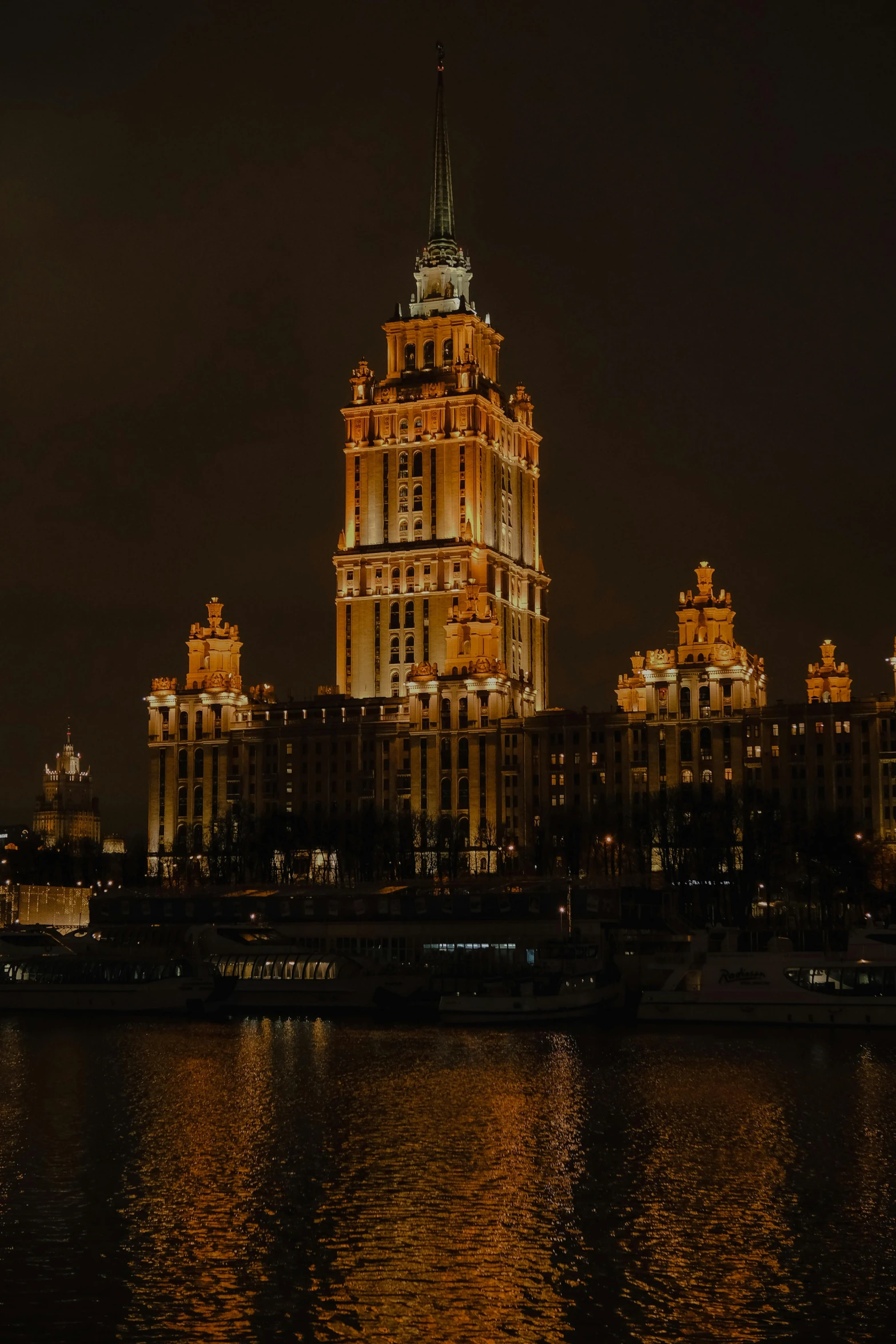 a large building with many windows in front of some water