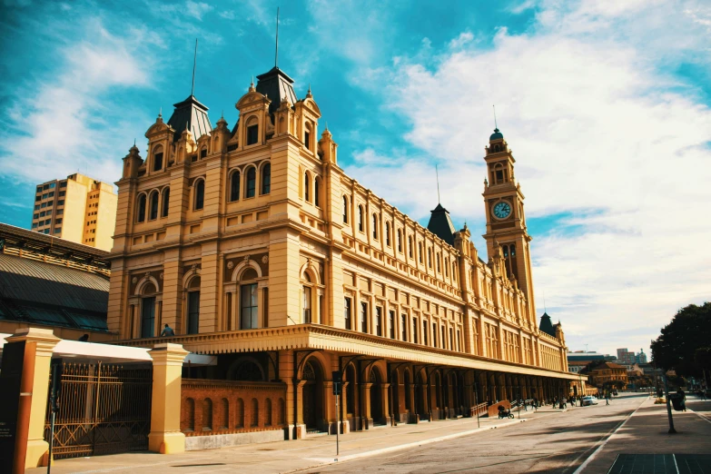 a yellow and brown old building with a clock tower