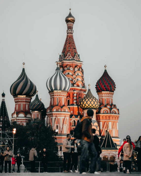 a group of people looking at the st basil cathedral