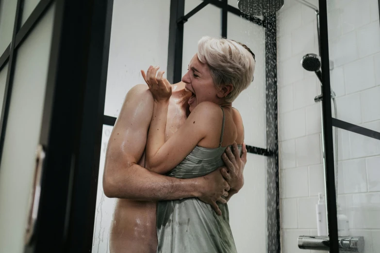 two women emcing in a shower while they stand