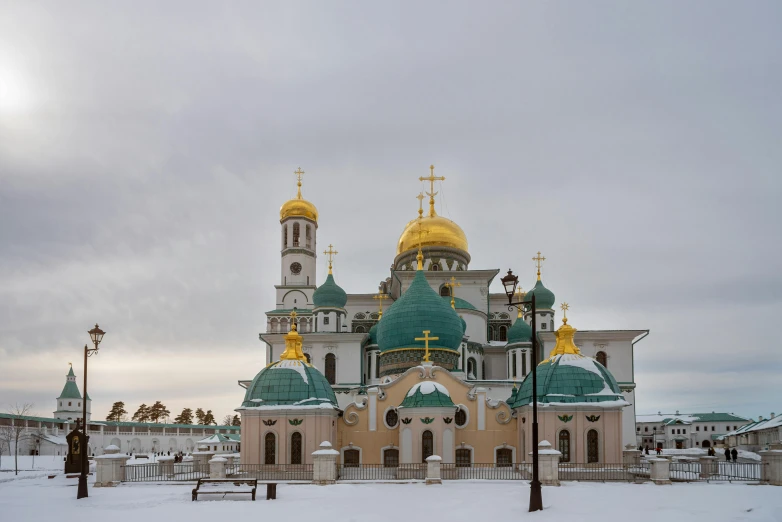 an ornate building with some golden domes and green domes