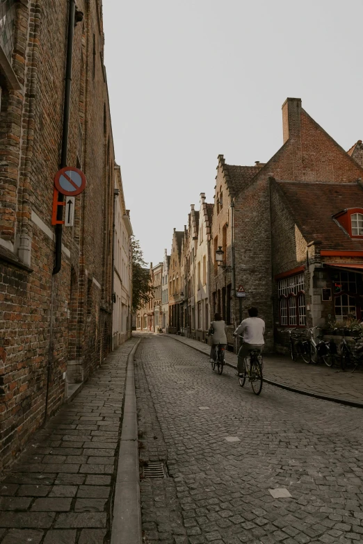 a group of people on bikes riding down a street