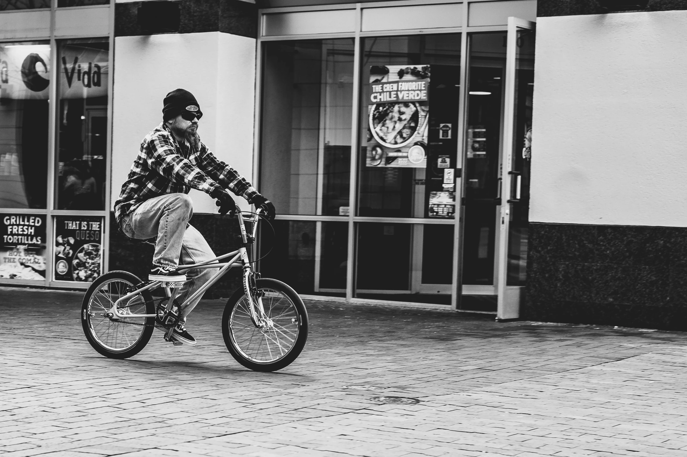 a man riding a bicycle down a street