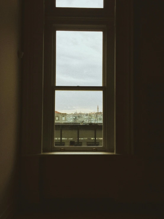 a window in a bathroom is open with sky as a backdrop