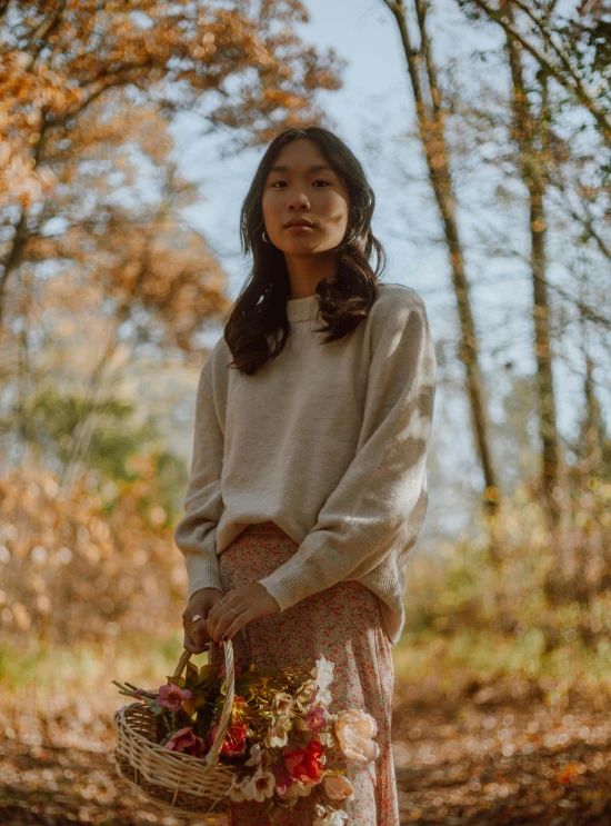 an image of a woman holding flowers in a fall scene