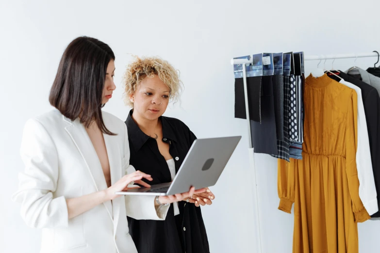 a woman using her laptop next to another woman