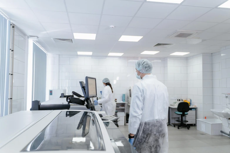 two technicians working in a white lab area