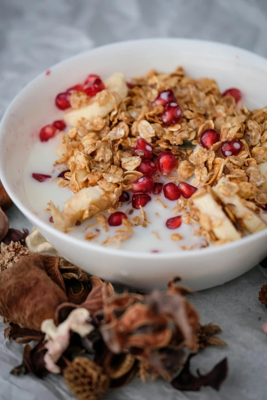 granola on top of some fruit in a bowl