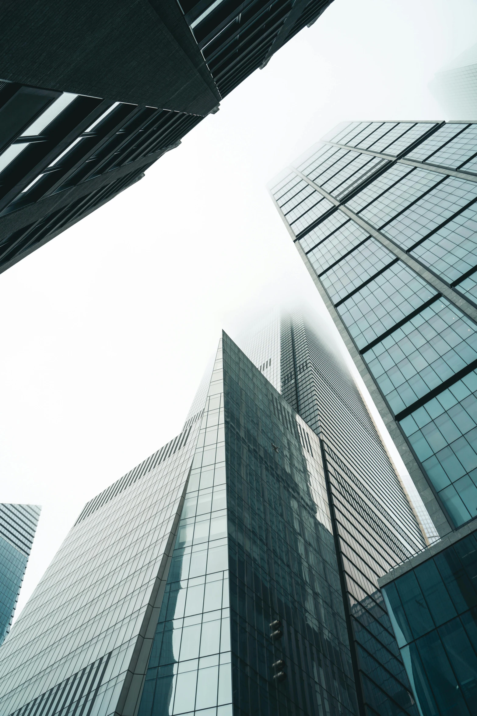 an upward view of two skyscrs that appear to be skyscrd