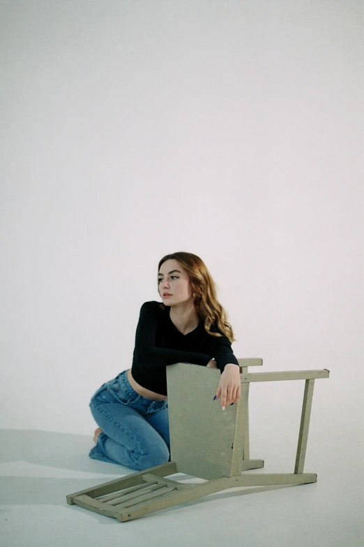 a girl is sitting down on a chair