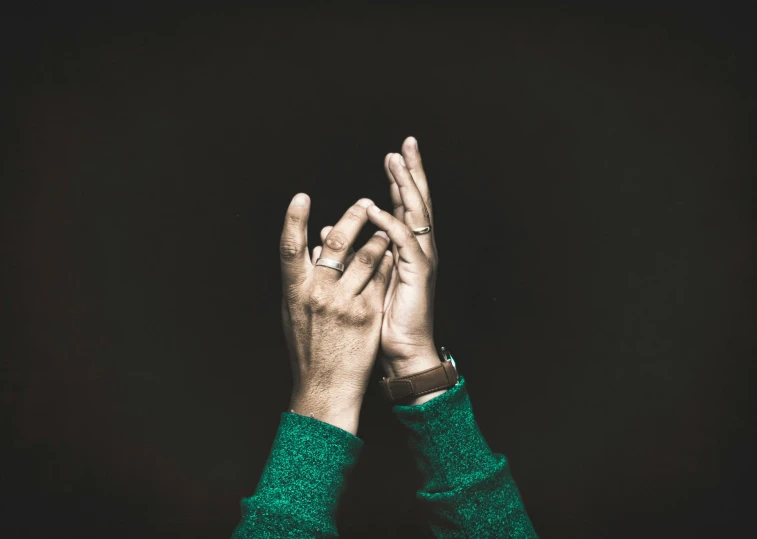 a person is posing with their hands up to spell soing