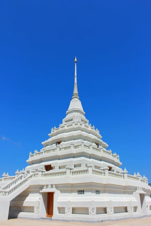 the roof of a large white building under a blue sky