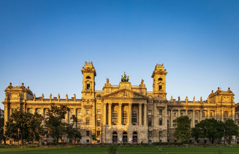 the large building has four towers on the roof