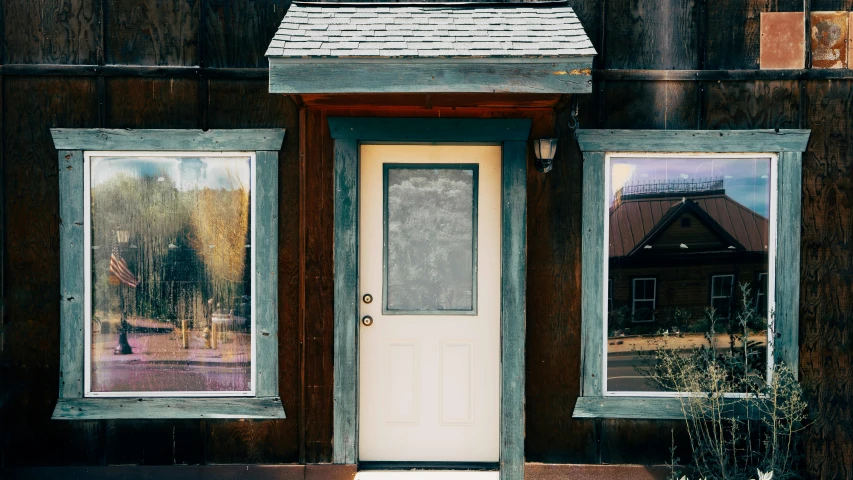 a door that is open and some windows on a house