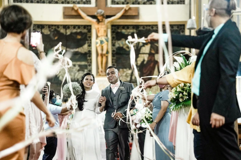 a man and woman walk down the aisle