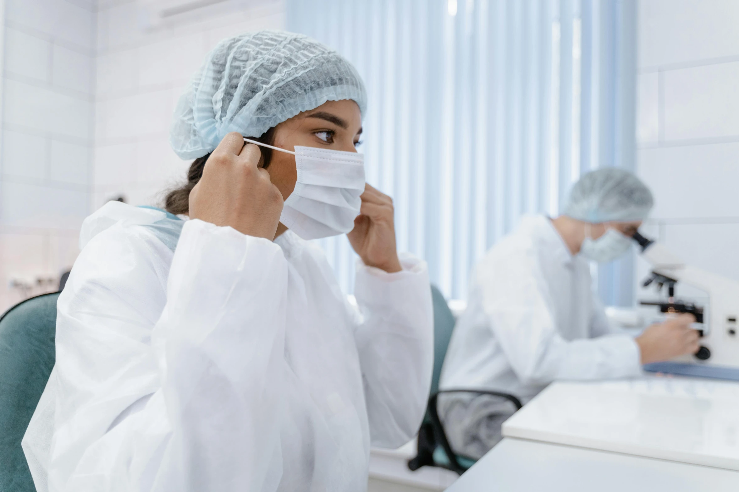 two people in sterile garb working at work