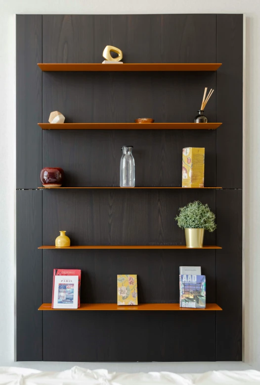 shelving units with books, vases and pictures on them