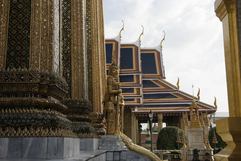 several elaborately decorated gold and silver buildings with statues
