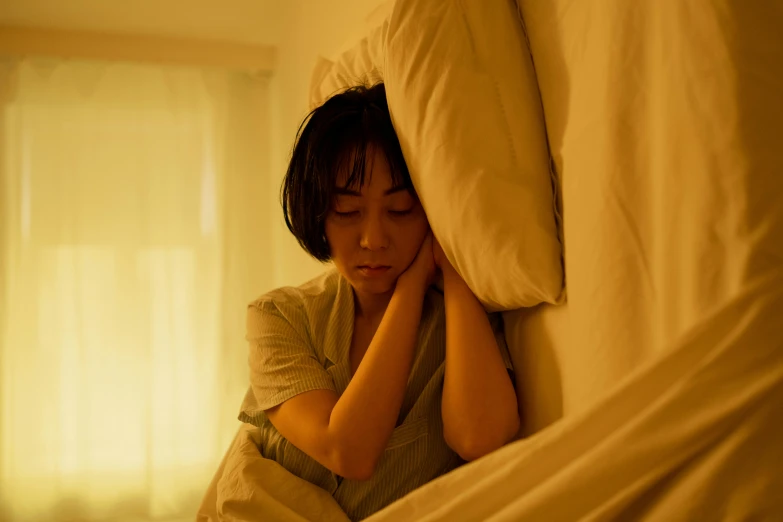 a woman holding a pillow in her bedroom