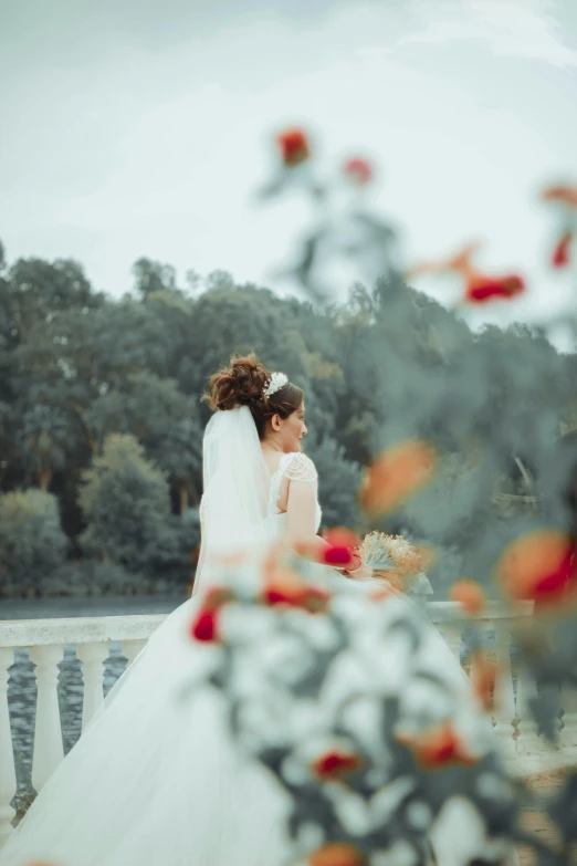 two women are sitting on a bench outside